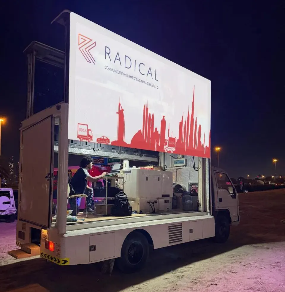 LED screen truck operating in Dubai at night, with the screen and control station visible